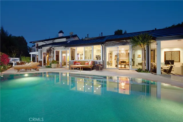 a view of a swimming pool with outdoor seating