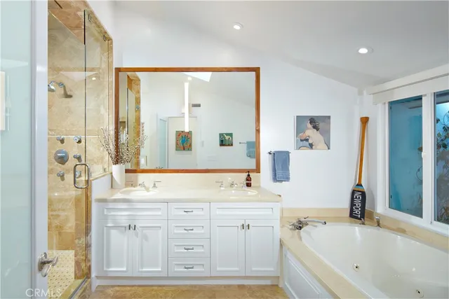a bathroom with a tub sink and mirror