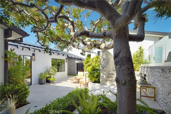 a front view of a house with a yard garage and outdoor seating
