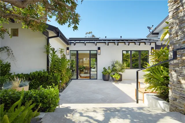 a view of a patio with table and chairs potted plants