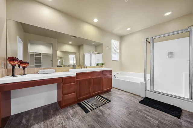 a large bathroom with a large tub and sink