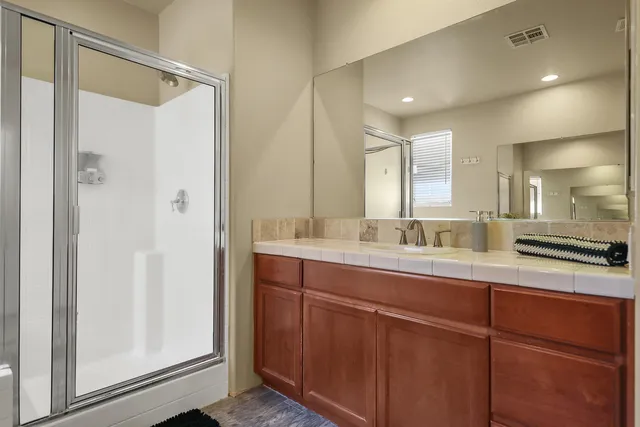 a bathroom with a granite countertop sink mirror and double