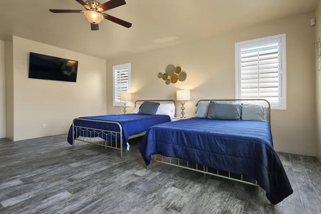 a bedroom with bed and wooden floor