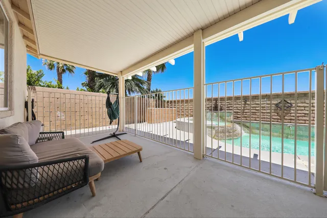 a reading room with furniture and a floor to ceiling window