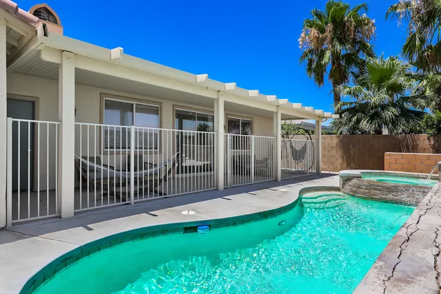 a view of a house with a yard and a garden