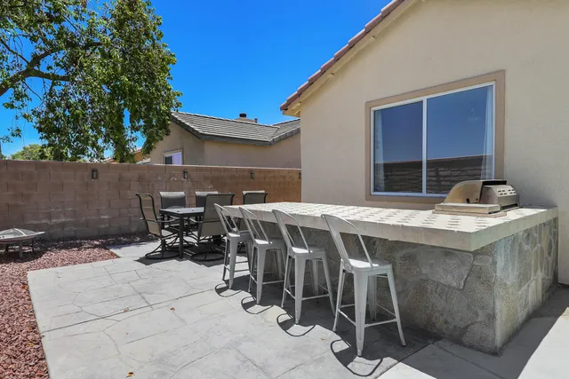 a backyard of a house with table and chairs