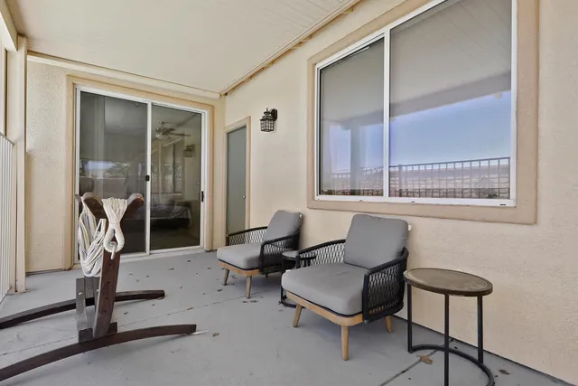 a living room with furniture a air conditioner and a large window