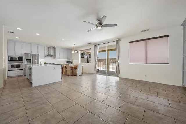 a view of a kitchen with furniture and stainless steel appliances