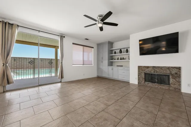 a view of livingroom with furniture fireplace and window