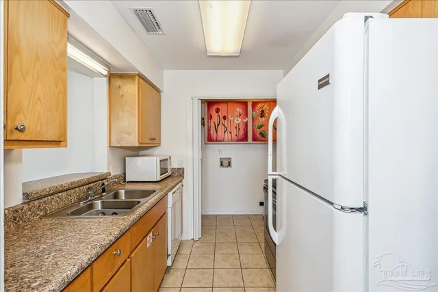 a kitchen with a sink stove and refrigerator