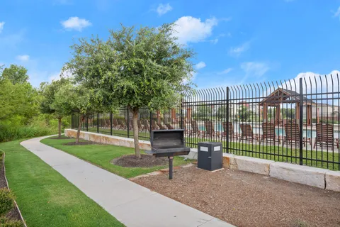 a view of a park with iron fence