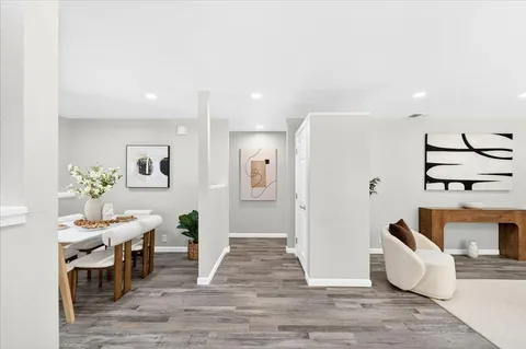 a living room with furniture and wooden floor