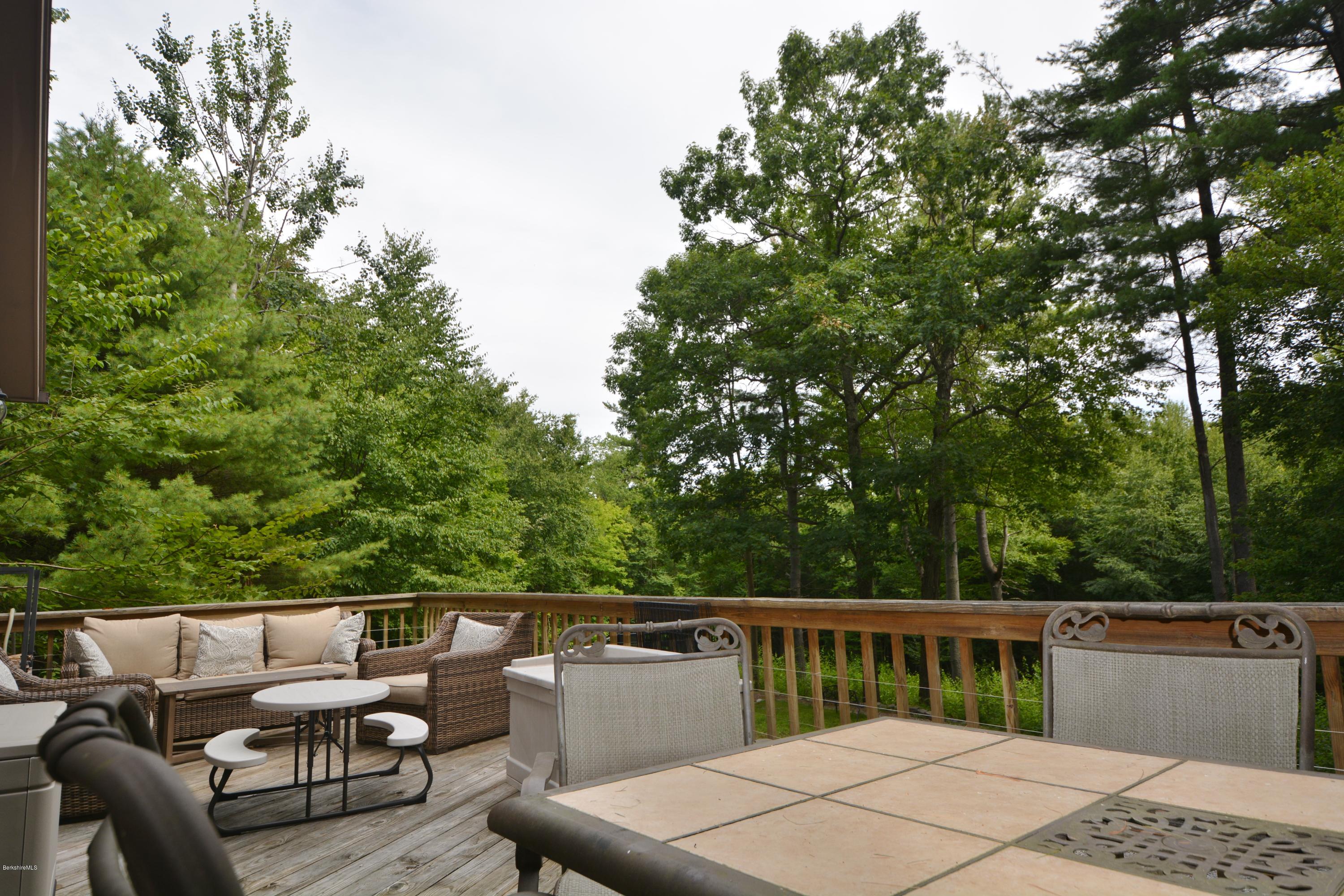 70 Rainbow Road Otis, MA 01029 - Photo 2 of 18 a balcony with wooden floor and outdoor seating