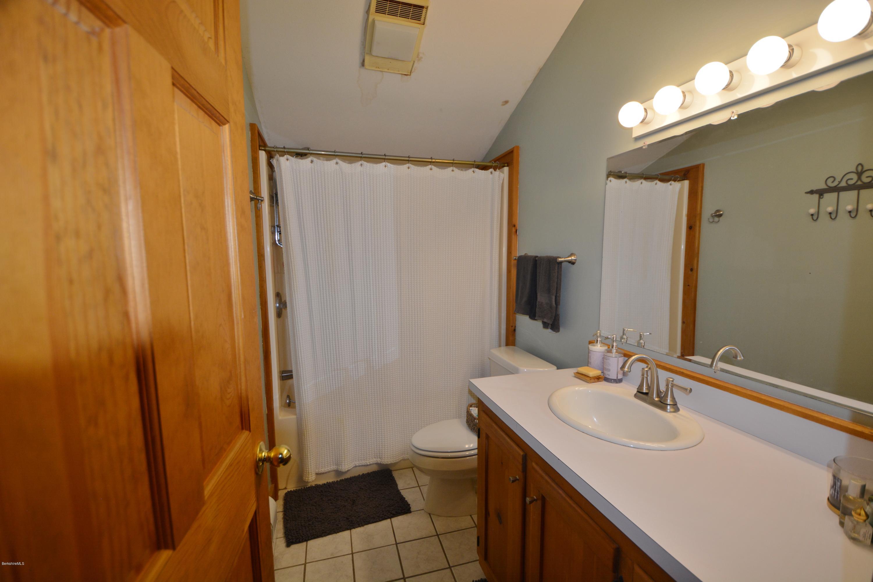 70 Rainbow Road Otis, MA 01029 - Photo 11 of 18 a bathroom with a sink a toilet and shower