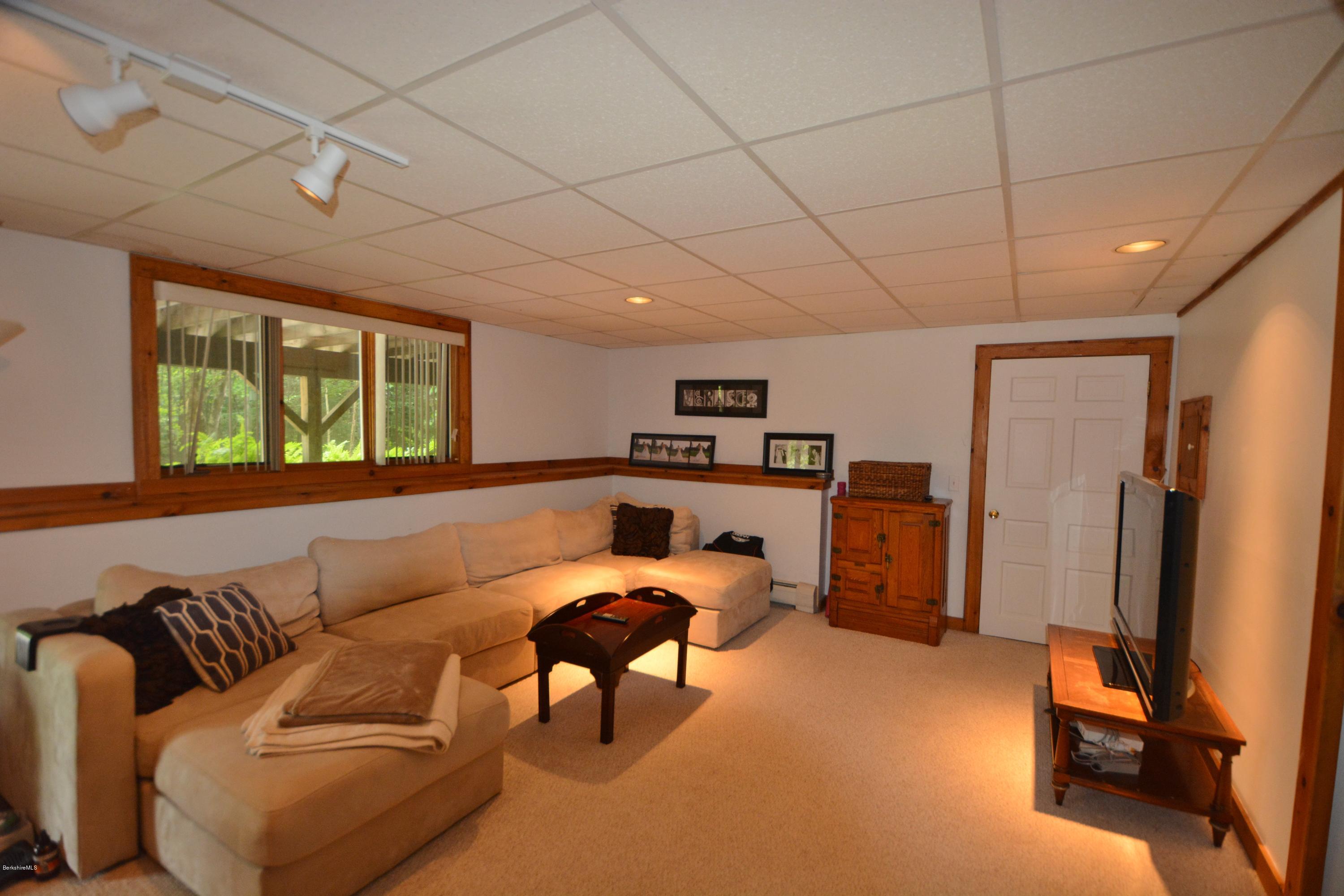 70 Rainbow Road Otis, MA 01029 - Photo 13 of 18 a living room with furniture a large window and gym equipment