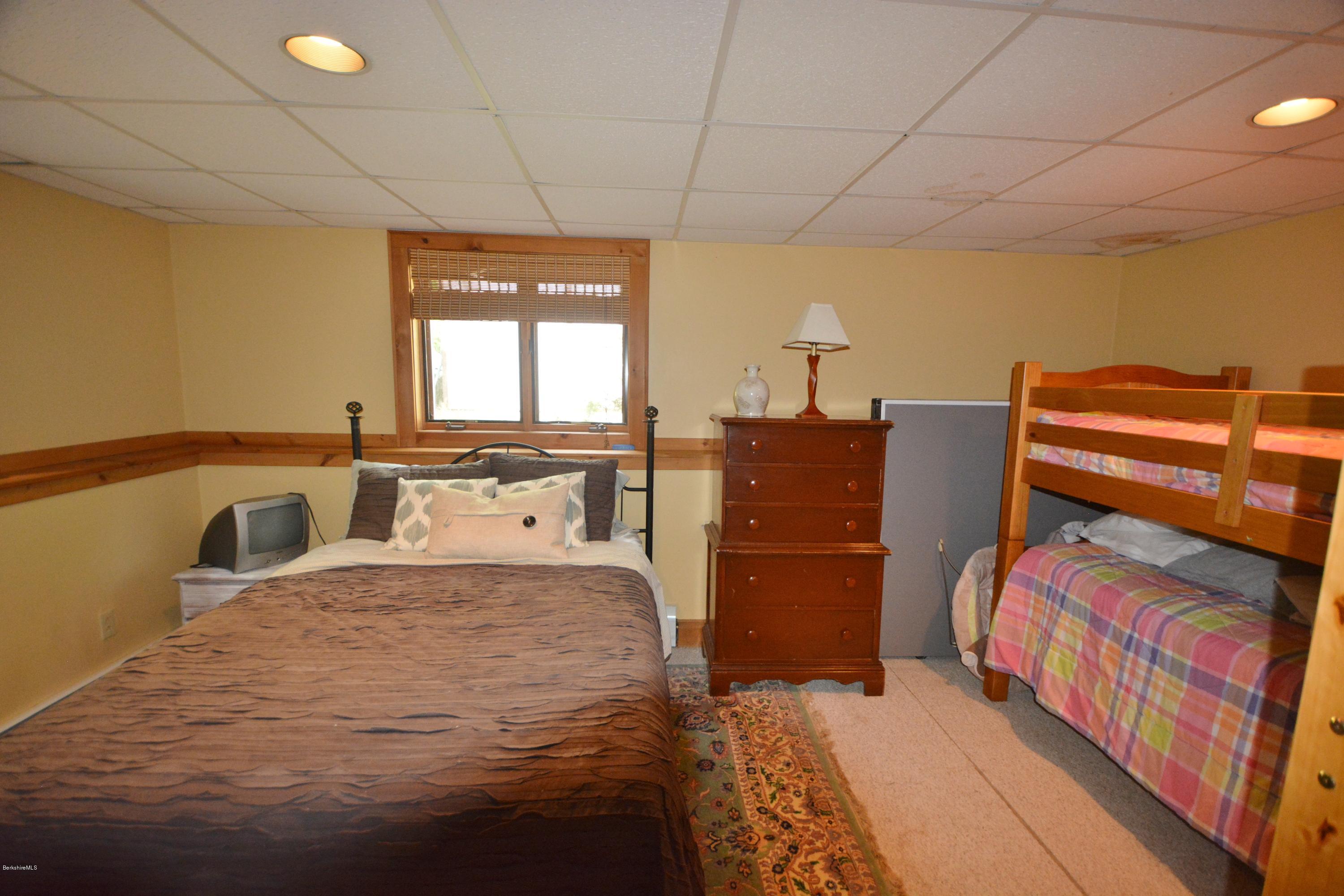 70 Rainbow Road Otis, MA 01029 - Photo 14 of 18 a bedroom with a bed and a cabinets