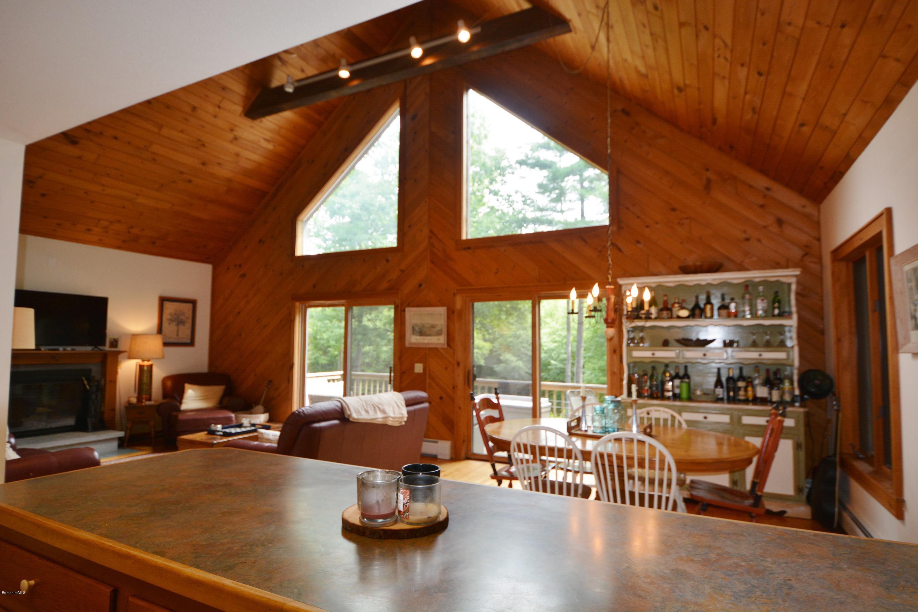 70 Rainbow Road Otis, MA 01029 - Photo 3 of 18 a room with furniture a large window and a chandelier