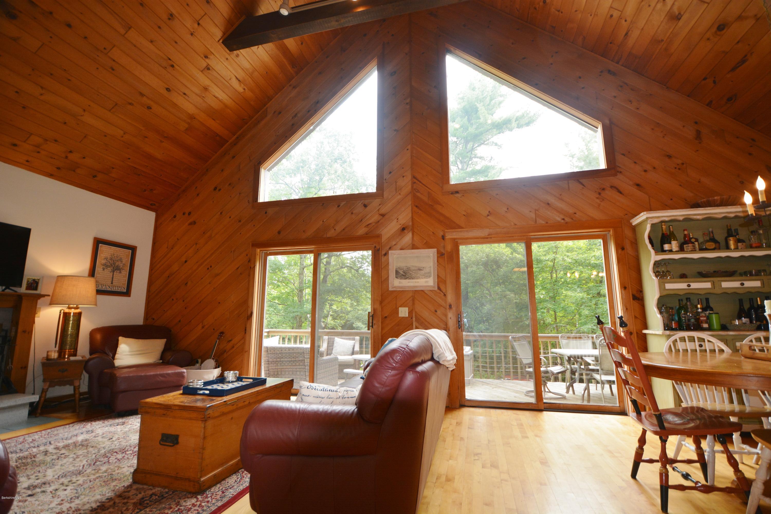70 Rainbow Road Otis, MA 01029 - Photo 5 of 18 a dining room with furniture and large windows