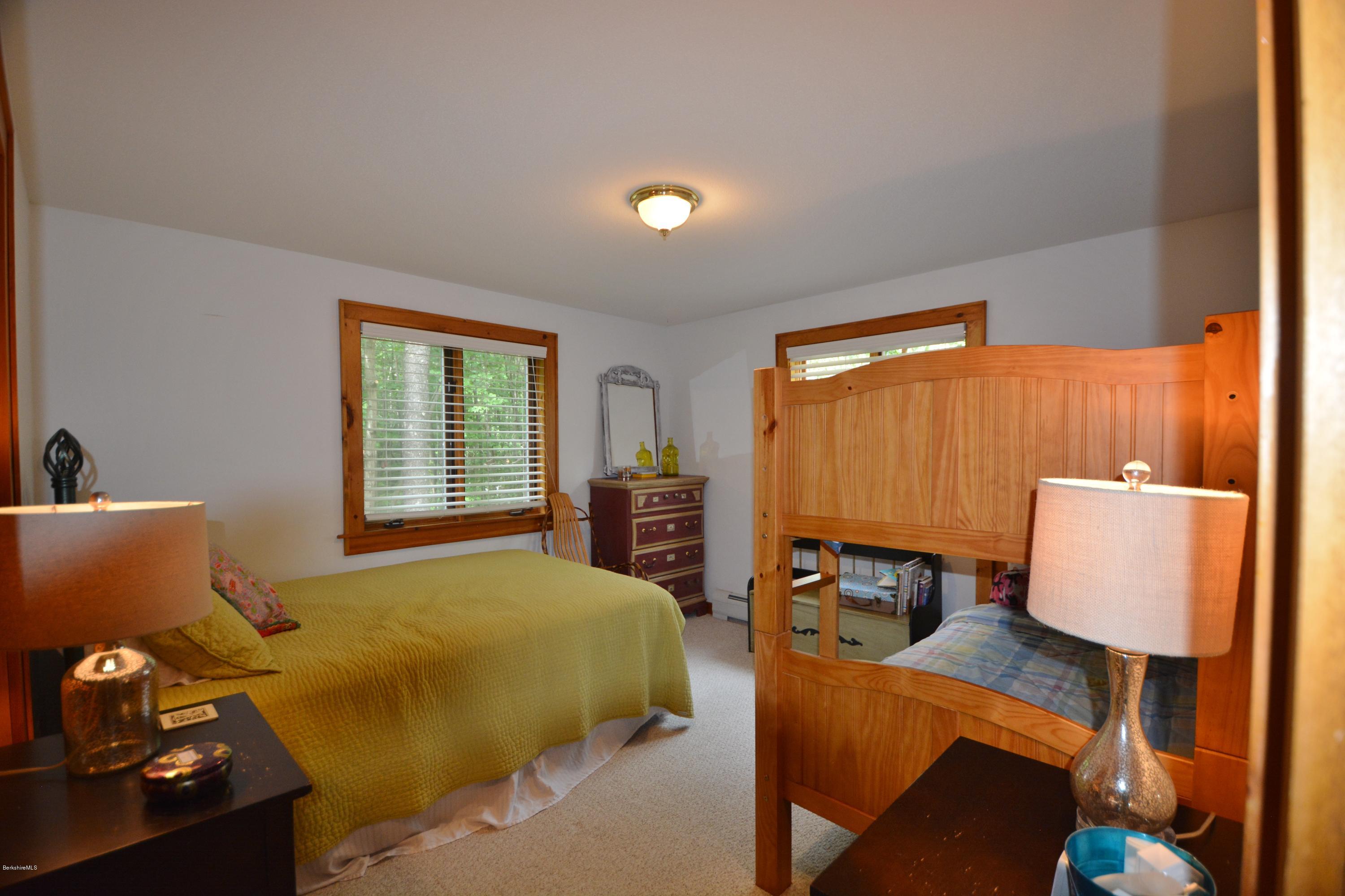 70 Rainbow Road Otis, MA 01029 - Photo 8 of 18 a bedroom with a bed and wooden floor