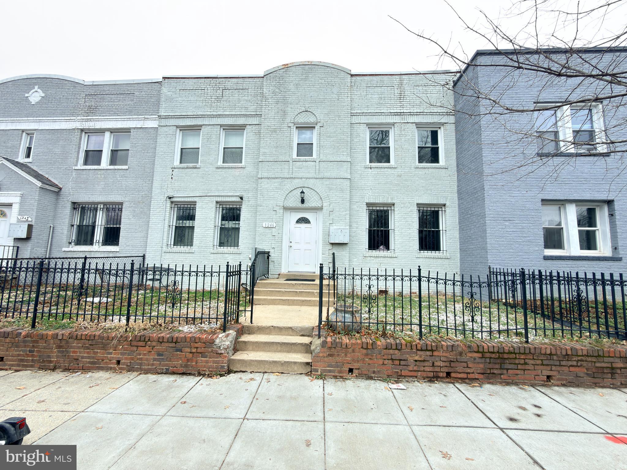 a view of a brick house with many windows