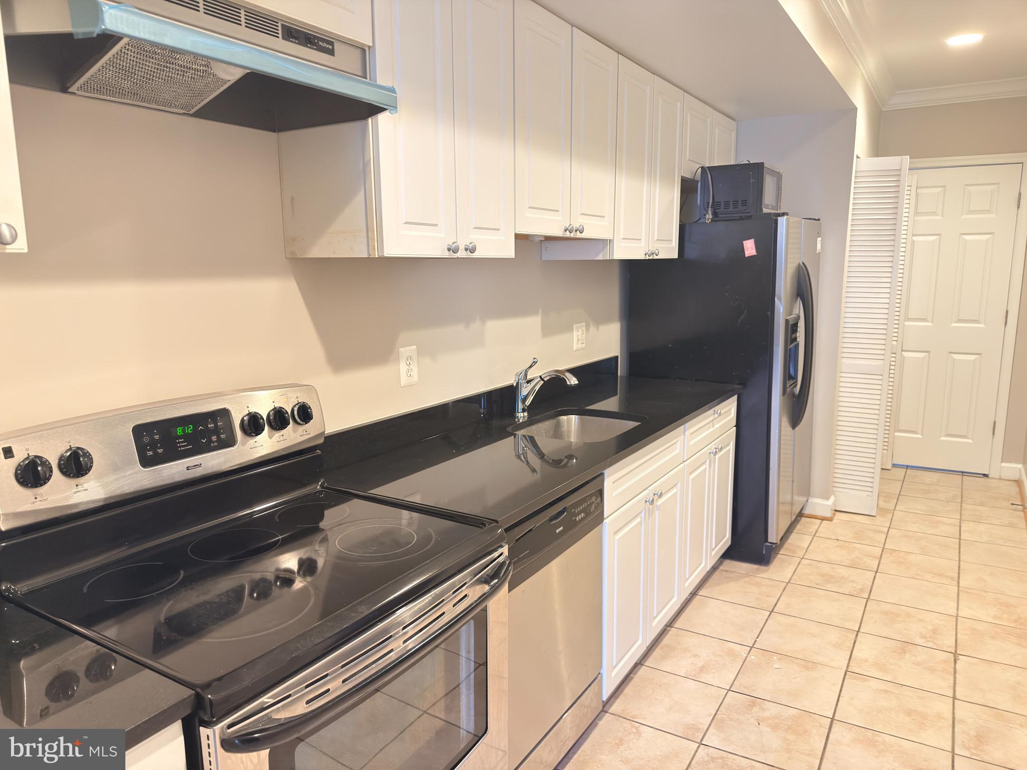 1246 Queen Street Northeast, Unit 2 Washington, DC 20002 - Photo 4 of 23 a kitchen with a sink appliances and cabinets