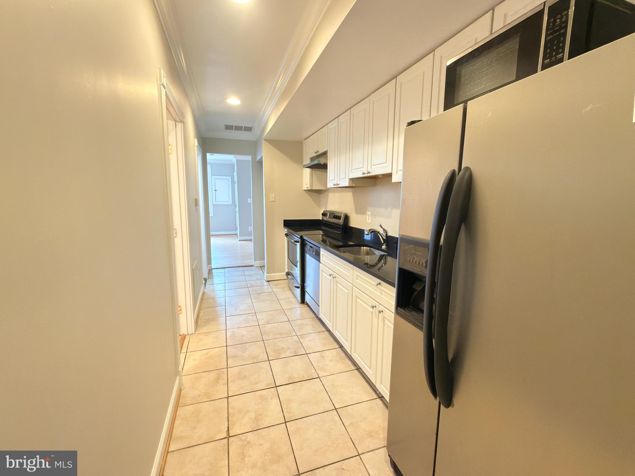 1246 Queen Street Northeast, Unit 2 Washington, DC 20002 - Photo 8 of 23 a kitchen with stainless steel appliances a refrigerator and a stove