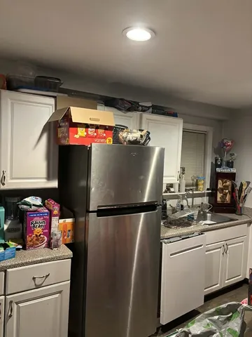 a kitchen with stainless steel appliances granite countertop a refrigerator and a stove