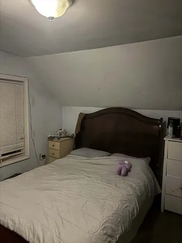 a bedroom with a bed and a closet