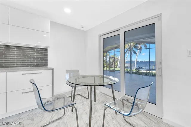 a large bed sitting in a bedroom next to a large window
