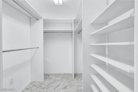a spacious bathroom with a granite countertop sink and a mirror