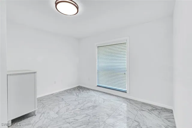 a bathroom with a granite countertop sink a toilet and a shower