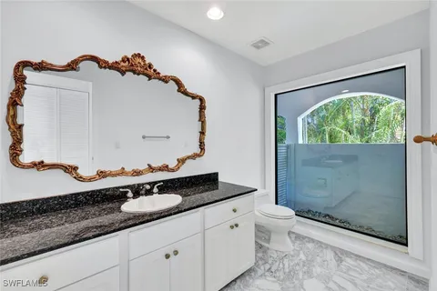 a utility room with a sink a stove and a window