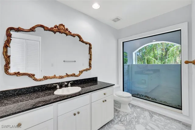 a utility room with a sink a stove and a window