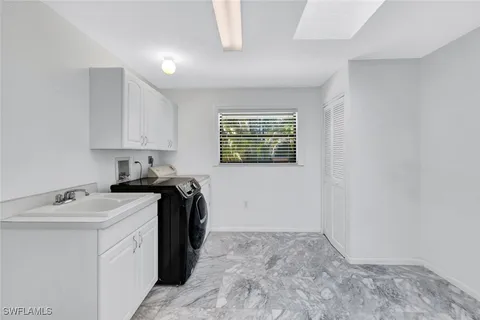 a view of a patio with a table and chairs under an umbrella