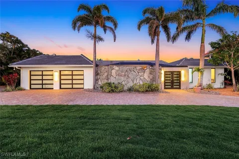 a view of a room with wooden floor and windows