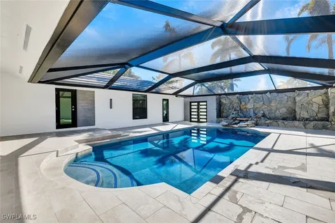 a swimming pool with an outdoor seating
