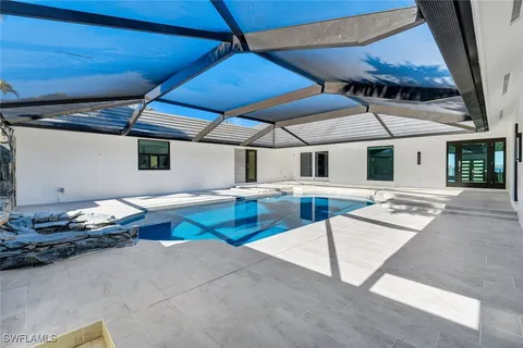 a dinning area with pool table and chairs