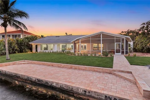 a view of a lake and sunset in the back
