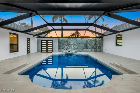a view of swimming pool with a garden and deck