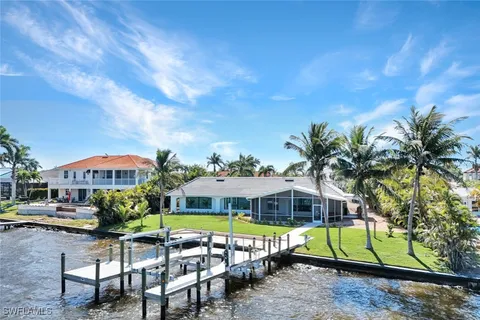 a front view of a house with a garden and patio