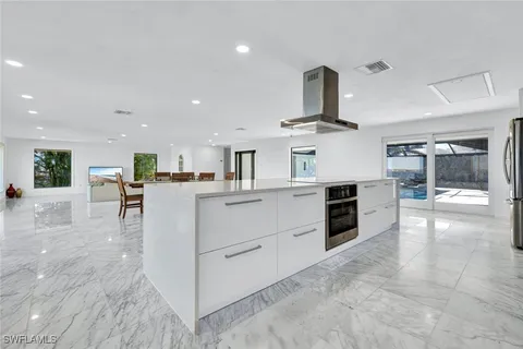 a kitchen with stainless steel appliances granite countertop a sink and stove