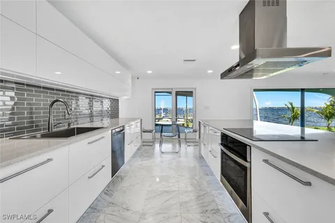 a view of a kitchen with dining table and chairs