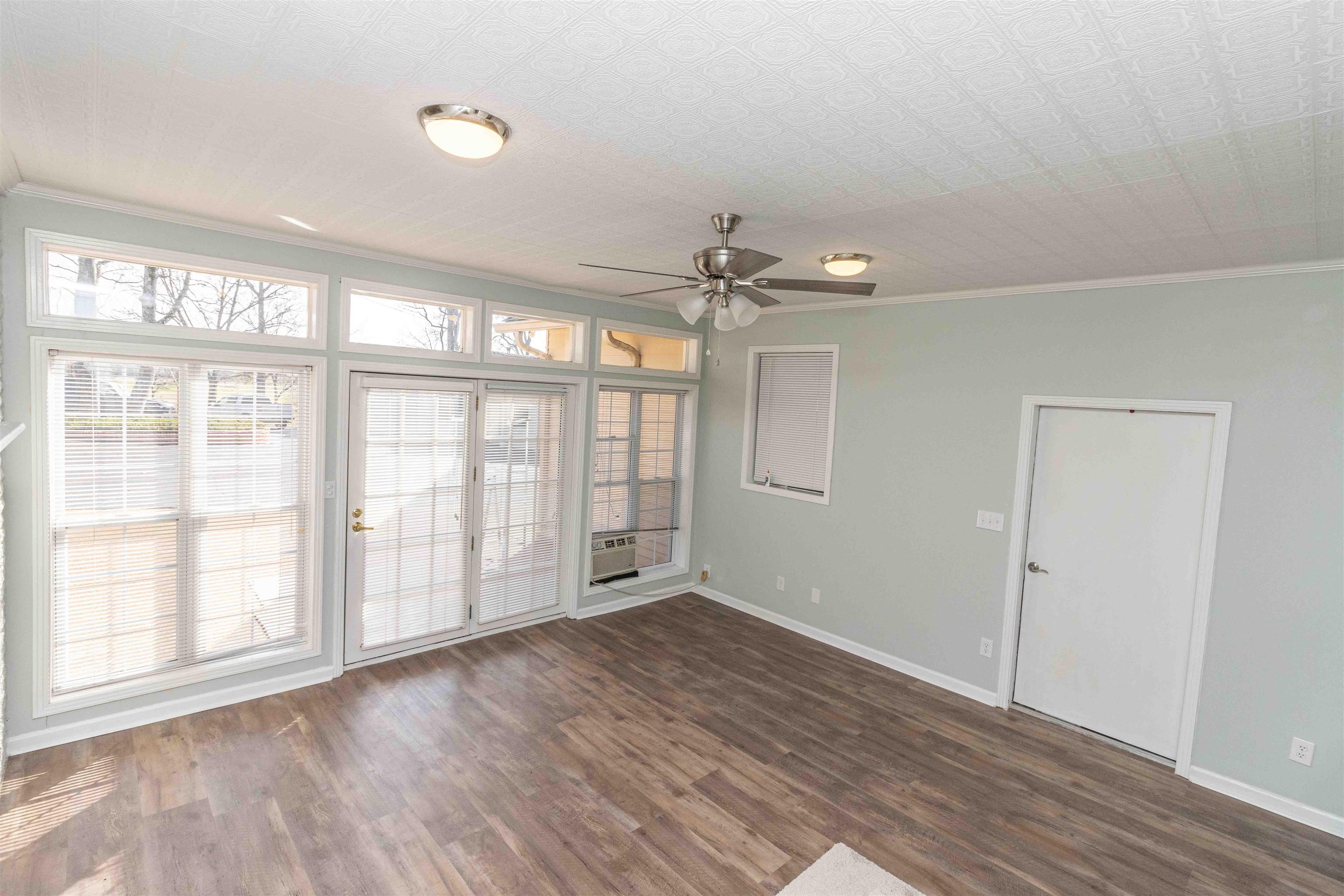 8453 Highway 45 Ramer, TN 38367 - Photo 13 of 40 a view of an empty room with a window and wooden floor
