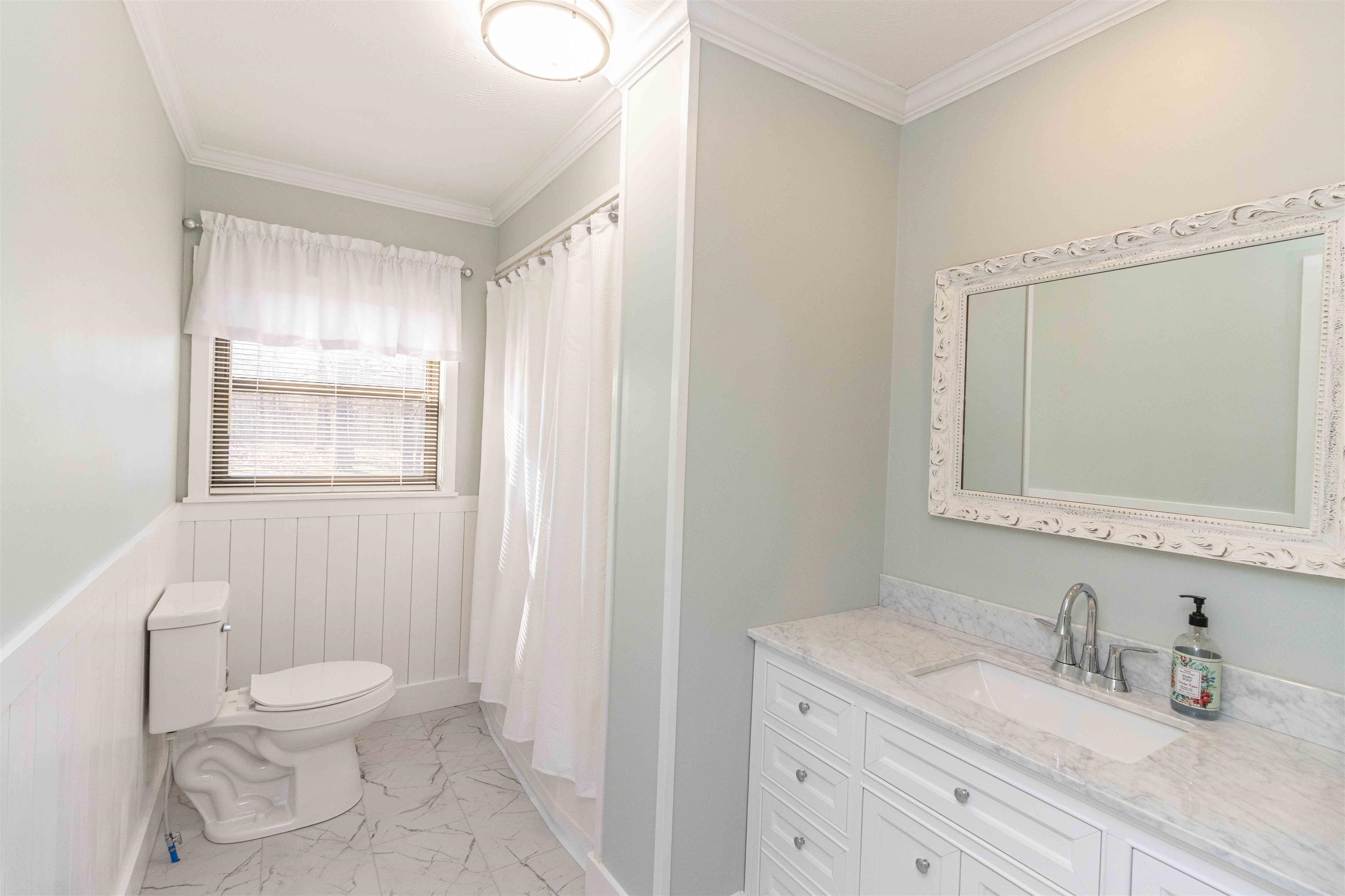 8453 Highway 45 Ramer, TN 38367 - Photo 23 of 40 a bathroom with a granite countertop sink a toilet and a mirror