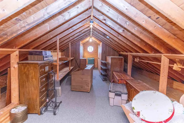 a front view of a house with a yard covered with snow