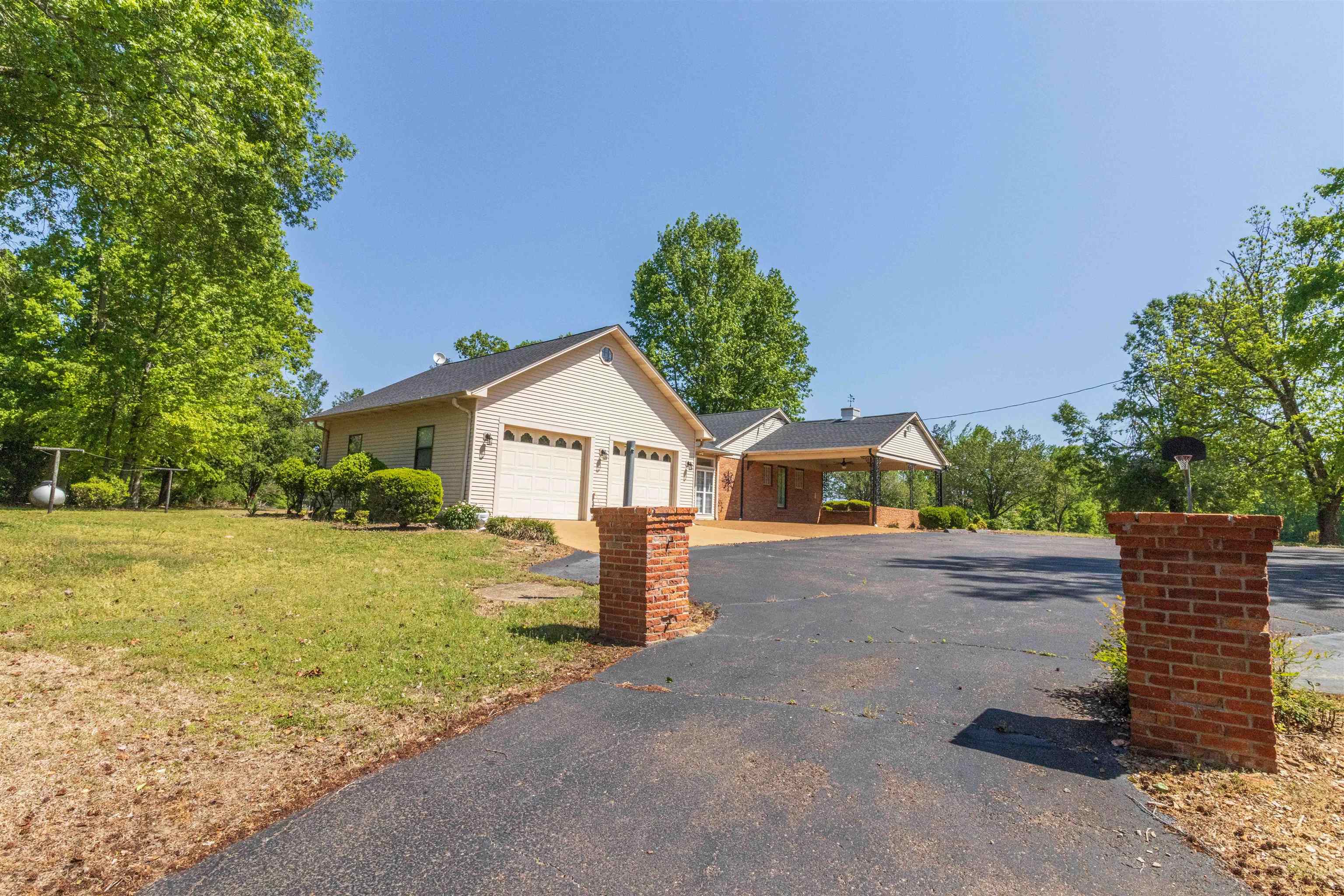 8453 Highway 45 Ramer, TN 38367 - Photo 6 of 40 a front view of a house with a yard and garage