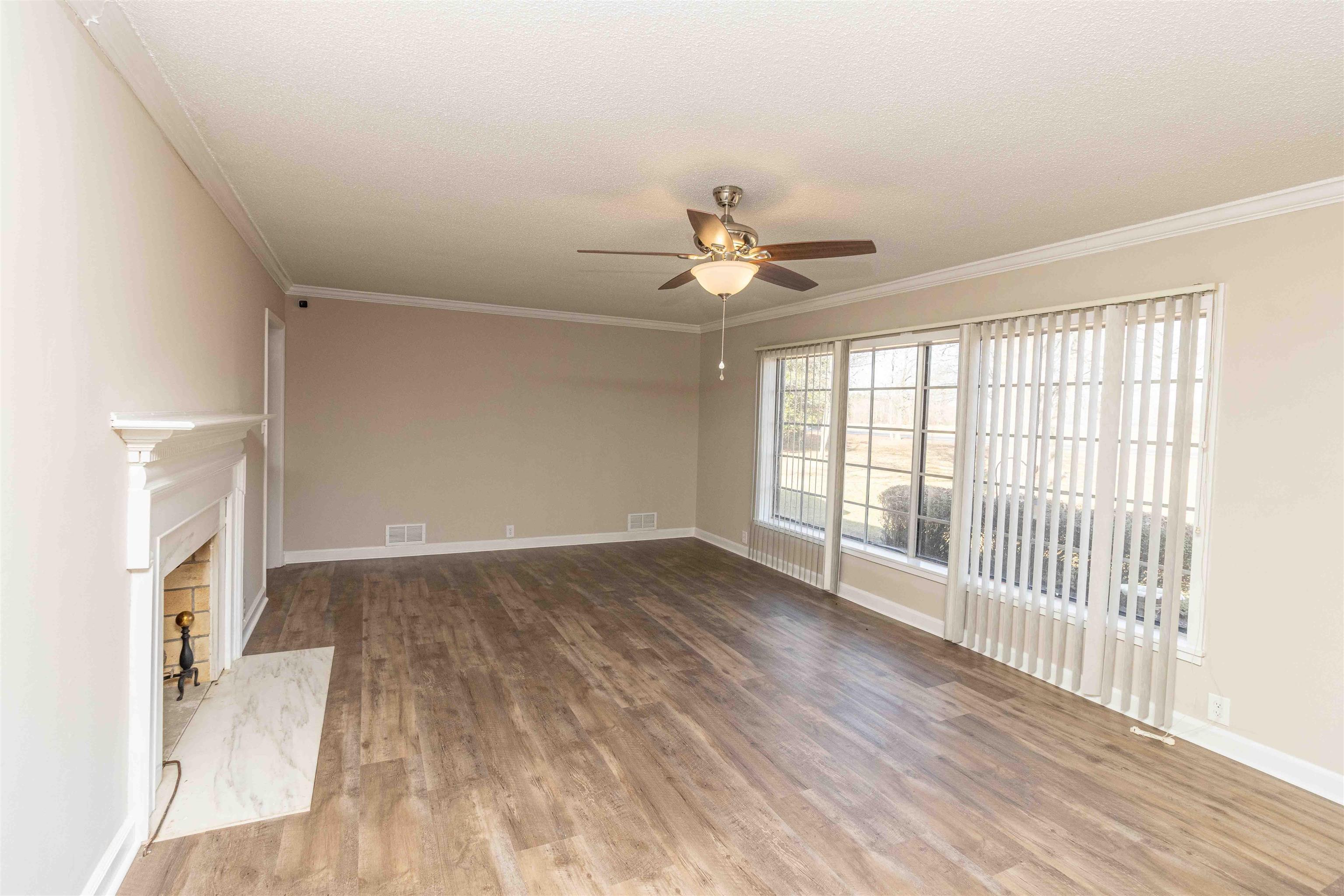 8453 Highway 45 Ramer, TN 38367 - Photo 9 of 40 an empty room with wooden floor and fan