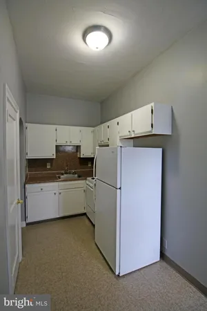 a kitchen with a stove a refrigerator and a sink