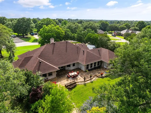 an aerial view of a house with swimming pool patio and outdoor seating