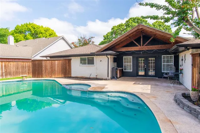 a swimming pool with patio outdoor seating and yard